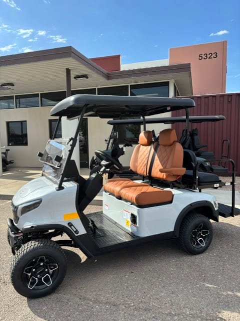 Side view of a white 2024 KANDI GOAT 2P with rear seat kit outside the Mesa storefront