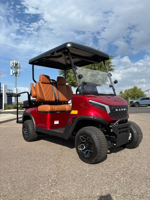Front three-quarter view of the red KANDI GOAT with cognac seats