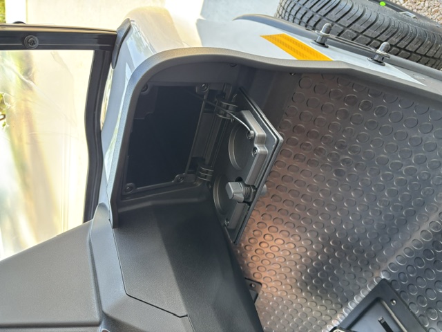 Open passenger-side storage cubby with cupholder on the Stone KANDI GOAT 2P