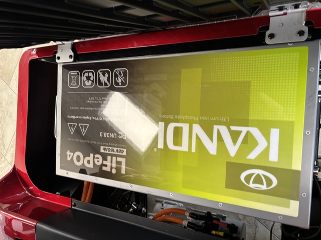 48V 150Ah LiFePO4 battery beneath the seat of the red KANDI GOAT 2P