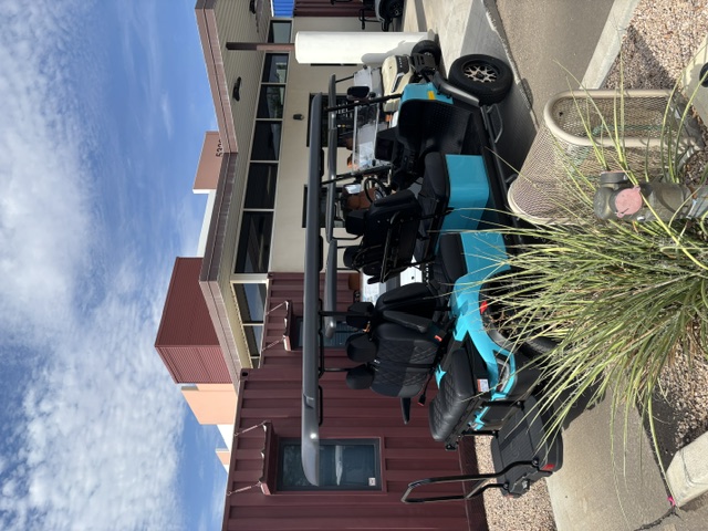 Turquoise 2026 KANDI Kruiser 6Pro-B rear three-quarter view with extended roof and rear seating