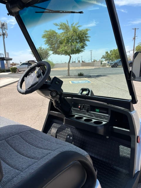 Cockpit of the 2018 Tomberlin with steering wheel, dash controls, and cupholders