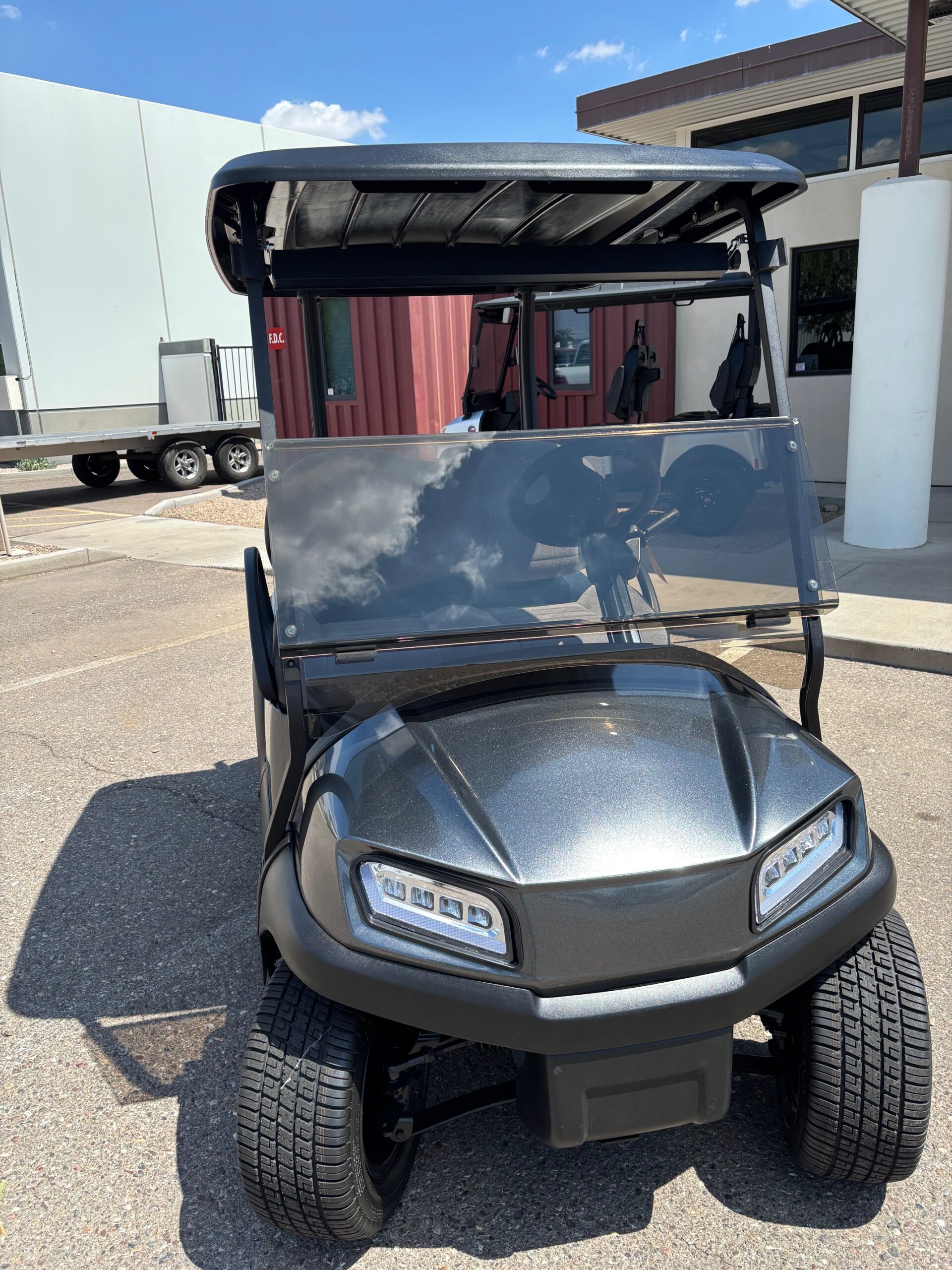 Grey golf cart photographed outside Arizona Golf Cart Repair