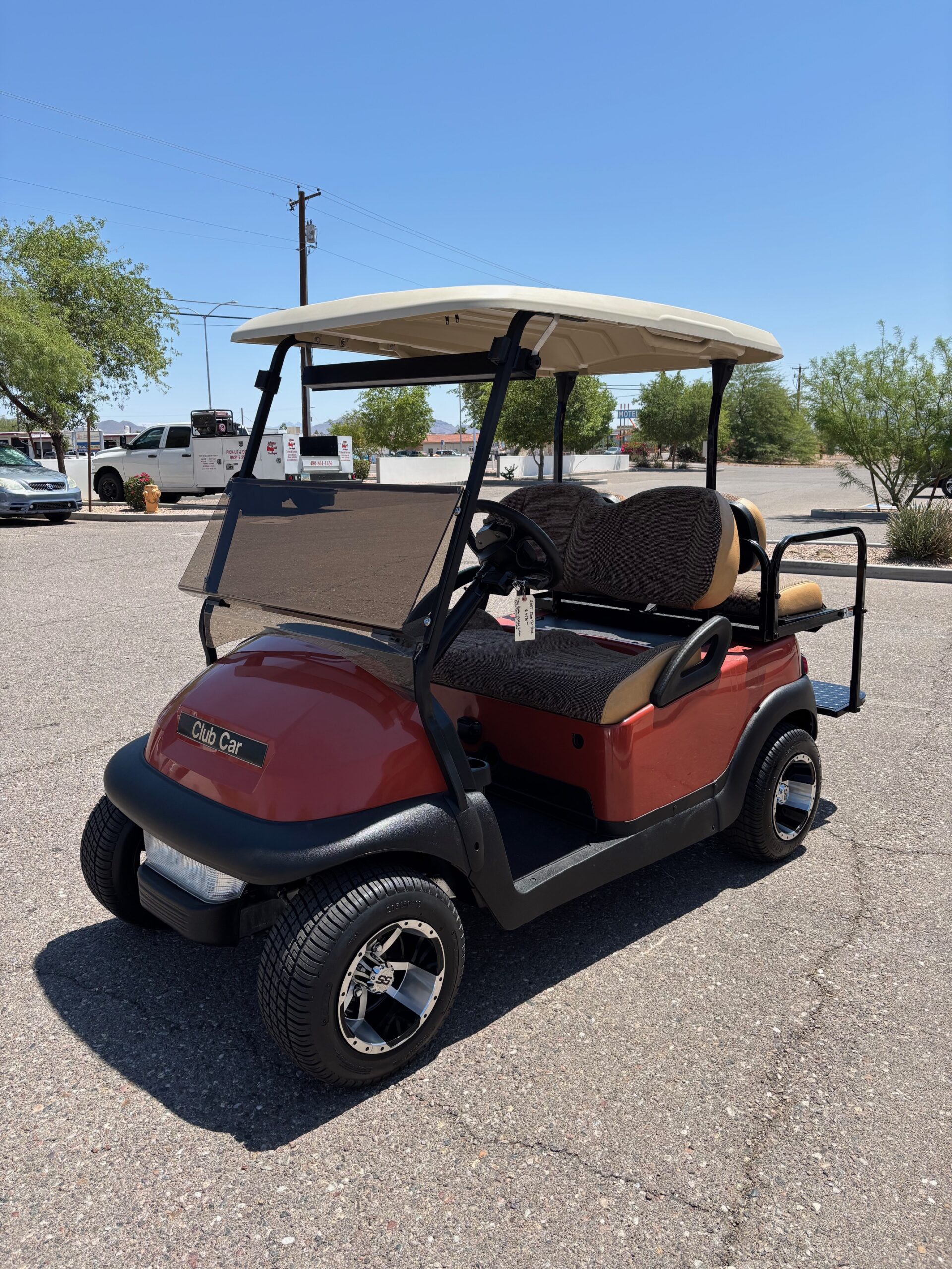 Custom red golf cart photographed outside the Mesa shop